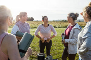 a group of people standing in a circle outdoors doing kegel excercises